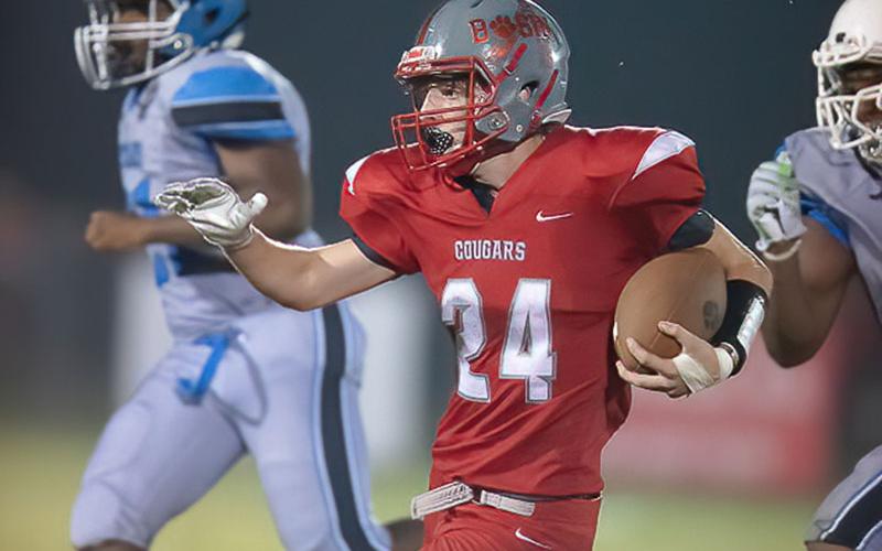 Copper Basin’s Harrison Brown looks to avoid tacklers in the Cougars win over New Faith Christian Academy.