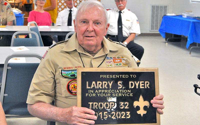 Larry Dyer displays the appreciation plaque given to him by Boy Scout Troop 32 of Epworth upon his retirement. Dyer was celebrated and honored for his many years of service at the Epworth Community Center among friends of Troop 32 and family.
