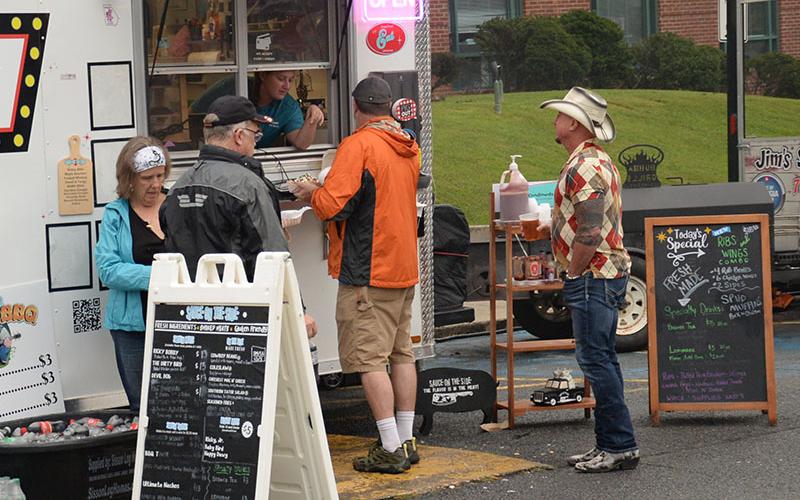 People lined up for barbecue offered by various vendors Saturday.