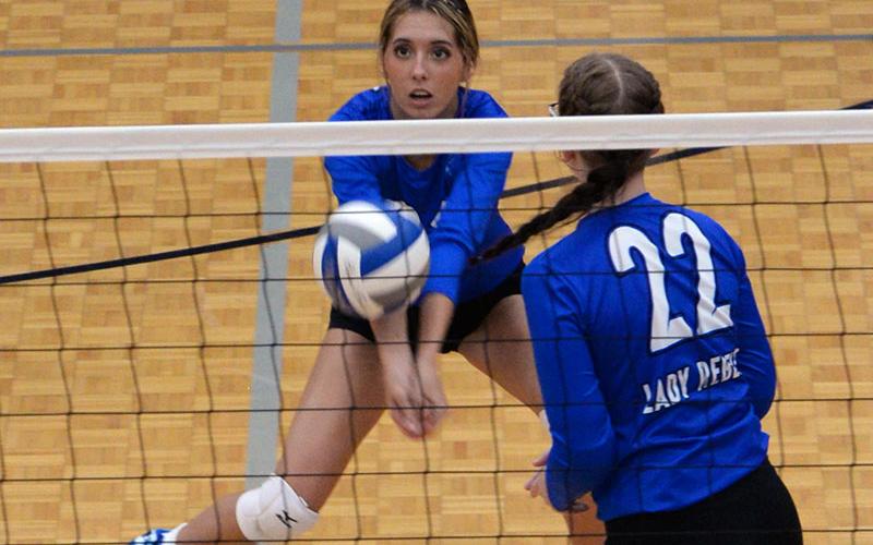 Peyton Slone sets up a return as Karis McIver (22) gets ready for a kill for the Fannin County Lady Rebels volleyball team.
