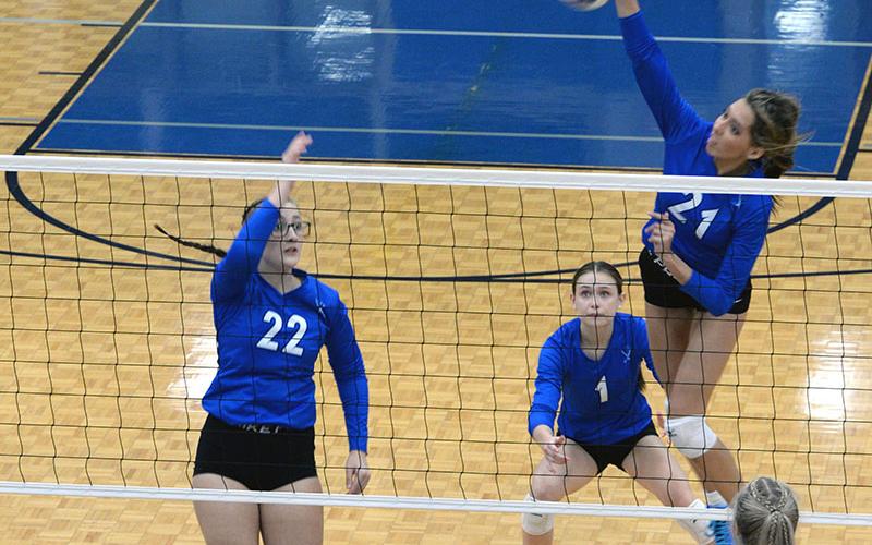 Peyton Slone looks for a kill while Karis McIver and Kaylie Davenport watch for the opponents’ next play in recent volleyball action.
