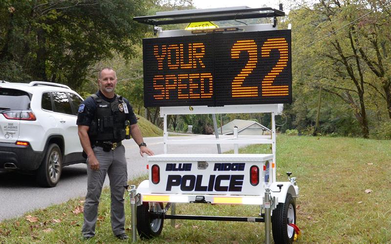 Blue Ridge Police Chief Robbie Stuart stands with the department’s new “eyes,” a portable speed detection/traffic control message board. It was in use on Church Street last week.