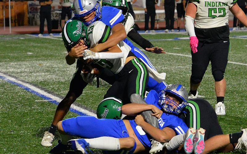 Scott Waldrep, on the ground, and C.J. Reece stop a Murray County runner in Friday night action at Fannin County High School. The Rebels posted a decisive 42-14 win in the Region 7-AA contest.