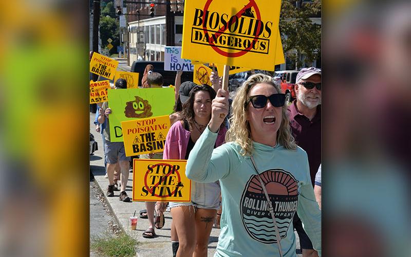 Protesters make their way up Grande Avenue toward City Hall in Copperhill last Wednesday. They expressed their concerns over the odor omitted from biosolids being spread at Copperhill Industries that are driving school students inside at Copper Basin schools, as well as possible effects on area water.