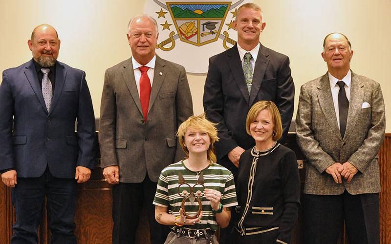 Lauralee Callegari, front left, staff writer for The News Observer, was recognized by School Superintendent Shannon Dillard-Miller, front right, for her articles covering recent school system events and news. Shown during the presentation of an handmade owl, the school system’s special honor recognizing wisdom and knowledge, are school board members, back from left, Mike Cole, Terry Bramlett, Bobby Bearden and Chad Galloway.