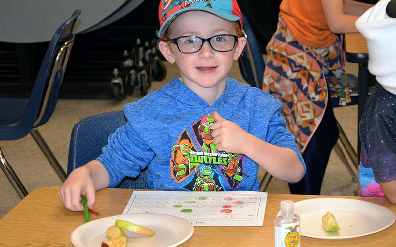 First grader A.J. Ellis tries different types of apples.