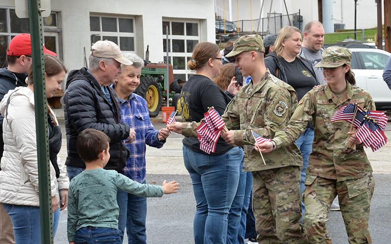 Members of the Christian Junior Reserve Officer Training Corps at Mountain Area Christian Academy (MACA) passed out American flags during the Veterans Day parade in Blue Ridge Saturday, November 11.