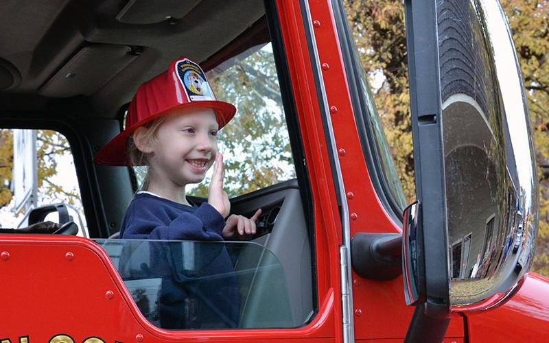 Kylee Hollins waved to parade watchers from a Fannin County fire engine.