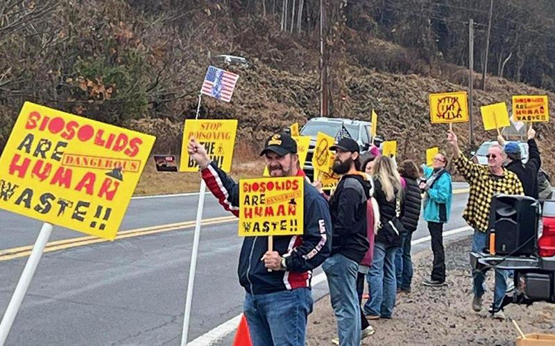 Citizens protesting the spread of biosolids and their smell are shown near the entrance to Copperhill Industries Saturday morning. They were forced to move twice, despite permission from race officials to hold their event.