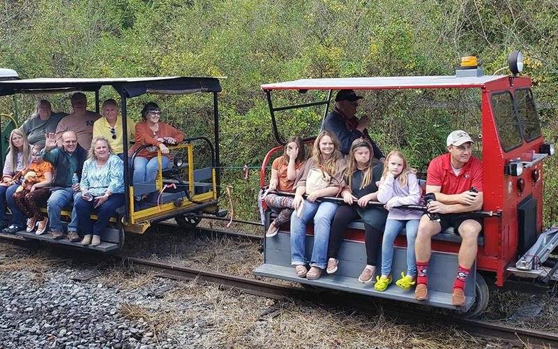 Shown are guests riding motor cars down some of Fannin County’s historic, restored railroad from the Mineral Bluff Depot during a previous Ride the Rails event.