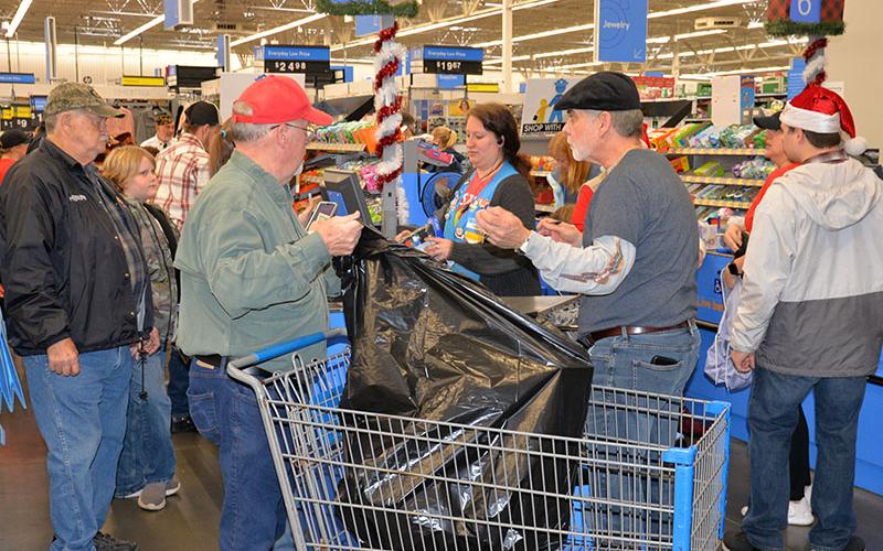 Bagging the toys and clothes purchased during Shop With A Cop was a full time job for several volunteers.