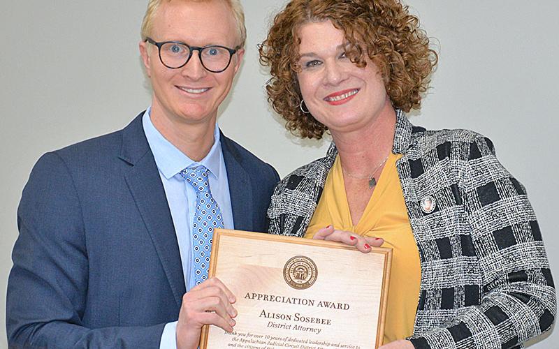 Frank Wood presented B. Alison Sosebee a plaque of appreciation from the District Attorney’s staff for her years of dedicated leadership and service to the citizens of Fannin, Gilmer and Pickens counties. Wood described Sosebee as, “My boss, my mentor, my friend,” as he introduced the award, which was created by Pickens County Sheriff Donnie Craig.