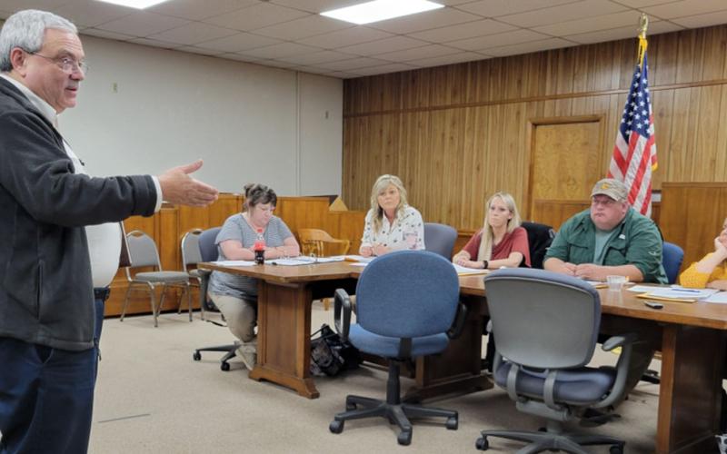 Tim Andrews, left, with the Tennessee Valley Railroad Museum, wants the Polk County Commission Board to create a railroad authority. Commissioners are skeptical, concerned about what might be hauled into Copperhill. Listening to Andrews’ proposal are, seated, starting second from left, commissioners Kelley Morgan, Samantha Trantham and Greg Brooks.