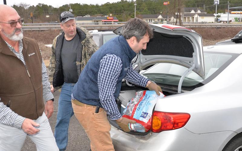 Ross Tarver and Kyle Cooper stayed busy loading water donated by Crystal Geyser Spring Water into residents’ vehicles last week. Tarver and Crystal Geyser worked together to provide free water after the Copperhill system went dry due to pipes burst by the frigid cold weather.