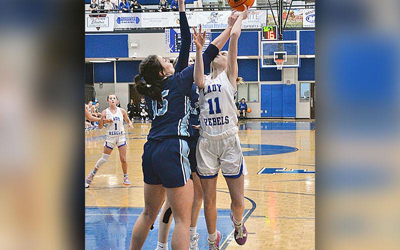 Lady Rebel Jace Sanderson drives hard for a layup in a tournament game against North Cobb Christian.