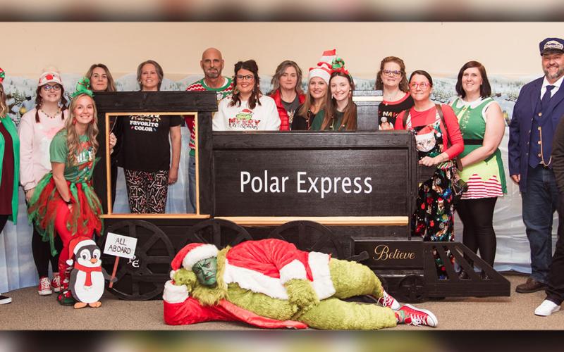 Helping host the accountability courts Christmas party were, from left, Christina Mosley, Nichole Panter, Kenzie Williams, Jodi Graves, Julie Panter, Chris Holt, Lindsey Ray, Michelle Green, Brandy Hamby, Courtney Pettit, Stephanie Bradford, Jennifer Dawson,Alyssa Dorman, John Arp, Noah Gibson, and  Assistant District Attorney Jefferson Adams as the Grinch.