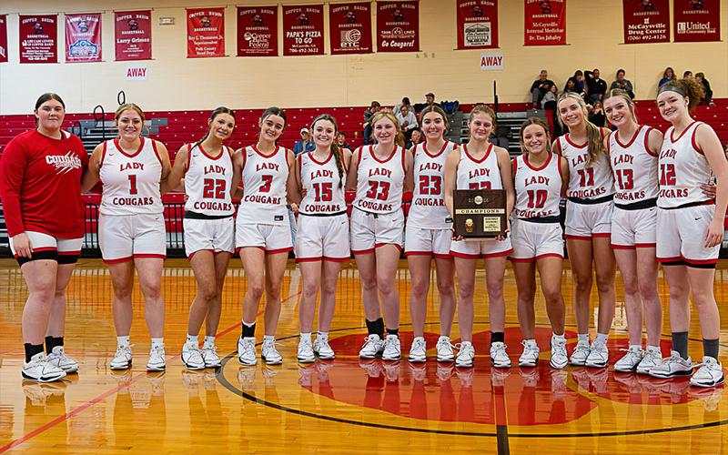 The Copper Basin Lady Cougars are shown with their District Championship trophy following their victory over Sale Creek. From left are Alyvia Harris, Claire Ledford, Addison Hyatt, Sarah Collis, Riley Akens, Cora Kimsey, Zoe Green, Riley Hall, Kendra Deal, Alexis Hyatt, Peyton Grabowski, and Kloie Ballew.