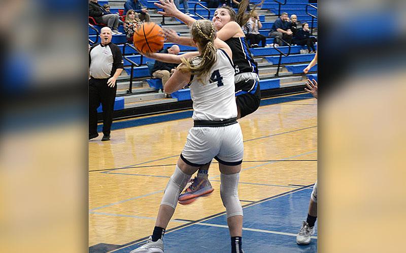 Courtney Davis goes up and around a defender as she drives the lane for the Lady Rebels.