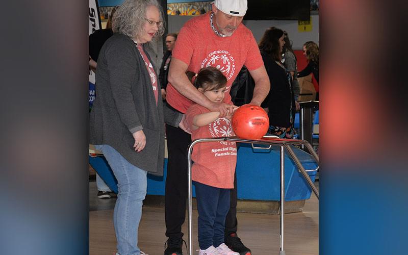 Sunshine Gibbs got a little help from Mr. Scott  and Andrea Cook during Special Olympics bowling at Fannin Lanes.