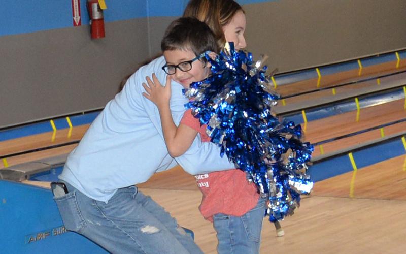 Carter Norton gets a big hug of congratulations from Fannin County High School cheerleader Kylah Imhoff at Special Olympics bowling. The annual event was held at Fannin Lanes in Blue Ridge Friday morning, February 23.