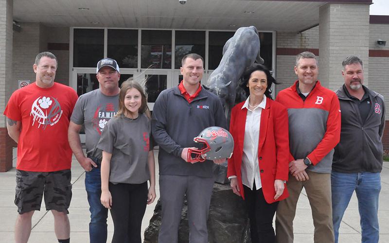 Copper Basin High School’s new head football coach Brett Graves, holding helmet, is pictured with, from left, Athletic Director Jeff Grimes, his father, Perry Graves, daughter, Callie  Graves, Principal Holly Smith, Assistant Athletic Director Kevin Smith, and middle school football coach Rusty Boggs.
