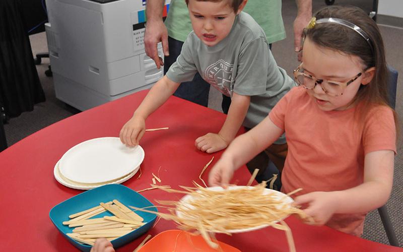 Siblings, Brenner Ramirez, left, and Olivia Ramirez used pop-sickle sticks, hay, and strings to make the perfect bird nest.