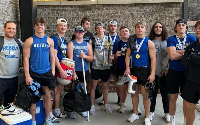 The FCHS Weightlifting team smiles  with their Runner-Up trophy after the state competition Saturday, March 2. Shown are, from left, Coach Wade Woodall, Lawson Sullivan, Cooper Born, Barron Davenport, Isaac Watkins, Braden Taylor, Case Holloway, Jacob Green, Carson Callihan, Jacob Dye, Bryson Cole and CJ. Reece.