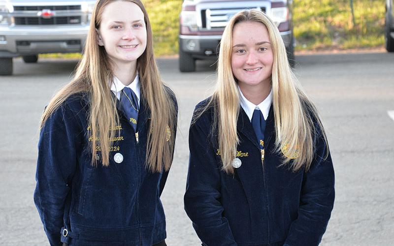 Fannin County FFA members Abby McFarland, left, and Kaleighann Ware read Paul Harvey’s So God Made a Farmer to conclude the first annual Seeds &amp; Farms, Gardens, Fields &amp; Herbs blessing at Mercier Orchards.