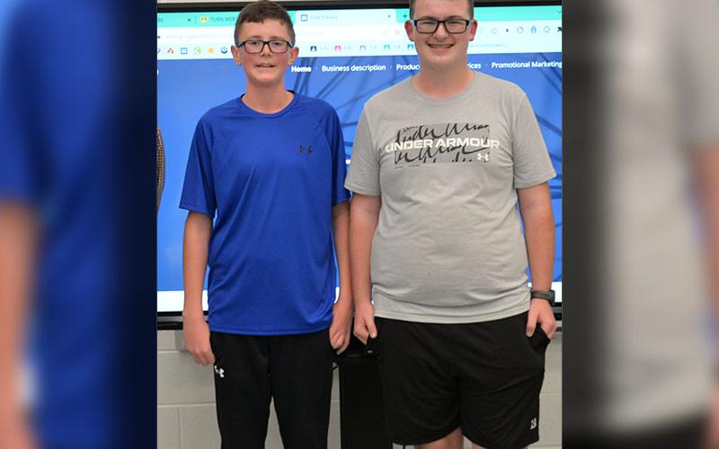Hunter Pierce, left, and Cale Weeks won third place at the Fannin Count Middle School Shark Tank with their race car and side by side wrapping business.