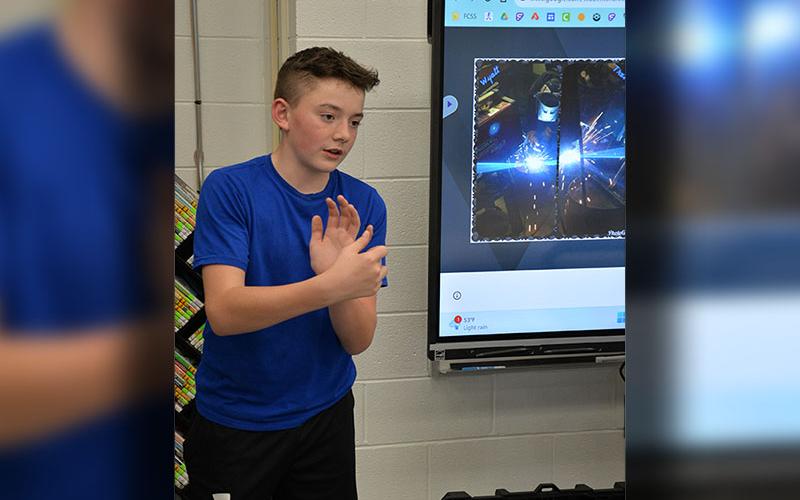 Wyatt Flowers works on selling Flowers Welding Services to Shark Tank judges as part of the competition Friday, March 8, at Fannin County Middle School.