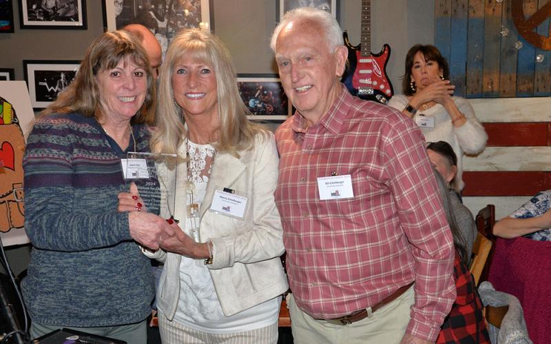 Sherry (center) and Bill Echelberger were recognized as Snack in a Backpack’s Community Champions  at the annual Champions for Children event Thursday, February 29, at Fightingtown Tavern. For a description of their contributions, please see page A10. Jeannie May, Snack chairwoman, presented the award.