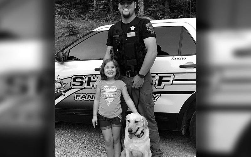 Dustin Carder and his daughter, Brintlie Carder, are shown with Dustin’s K9 partner, Lucho.