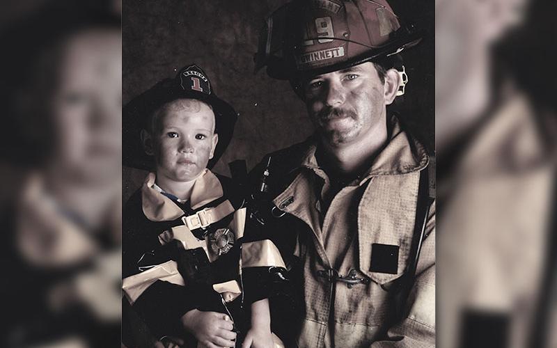 Both his grandfather and father had been firefighters and Geoffrey had long felt the desire to follow in their footsteps. A young Geoffrey Daves sits with his father, Jerry Daves, for a firefighter photo shoot.