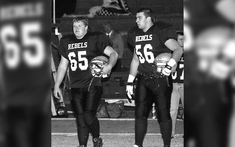 Geoffrey Daves and Bryant Meeks walk off the field after a game at Fannin High. Geoffrey played offensive line with his cousin, Logan Daves and Meeks.