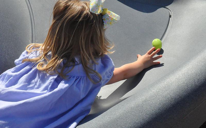Claire Trawick reached as far as she could to grab an egg during the Easter egg hunt at Epworth First Baptist church.