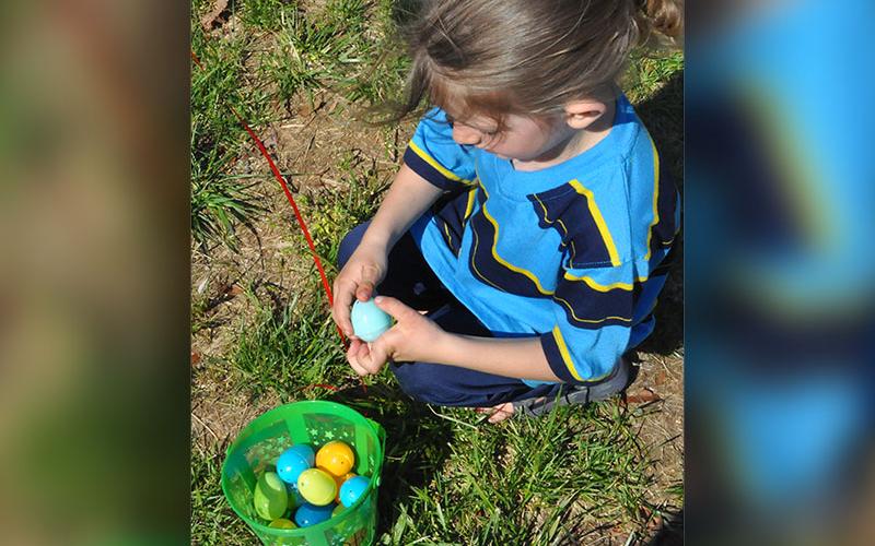 Sage Bennett sat down to relax after the egg hunt and checked each egg to see what was inside each one.