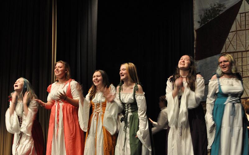 Cast members, from left, Elizabeth Oliver, Brooklynn Siler, Abigail Jackson, Gretchen McFarland, Emily Ableman, and Liliana Kenniff play women in the village swooning over Gaston in Beauty and the Beast.