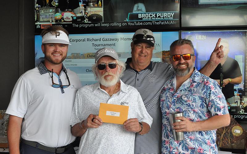 Mitchell Construction took first place in the Corporal Richard Gazaway Memorial Golf Tournament. Accepting the award are, from left, Taylor Cato, Brett Mitchell, Bob Martin, and Frank Mayer.