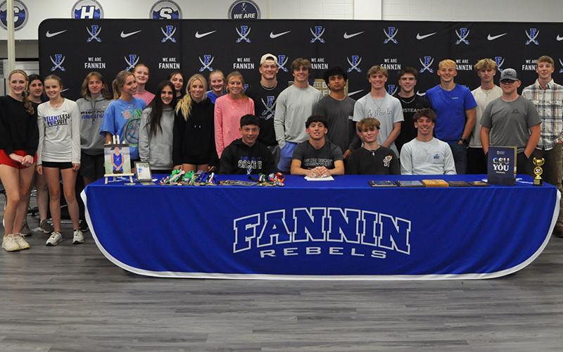 News Observer photos/Catrina McQuigg Members of Fannin County High School’s Track and Field teams gather to congratulate Zecharian Prater on his Letter of Intent signing.