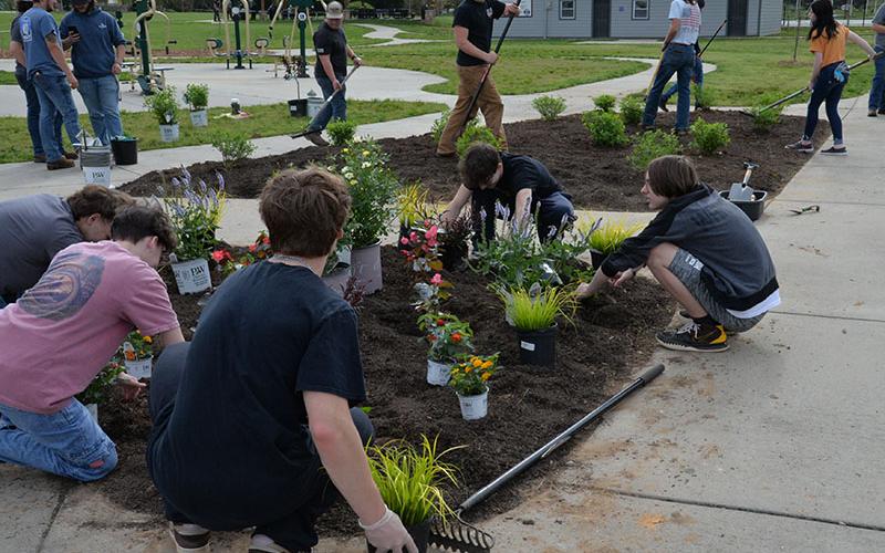 All the students got in on the work to plant flowers in the Toccoa River Park.