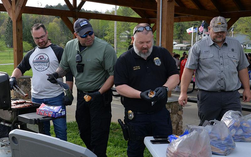 McCaysville Police Chief Michael Earley, Officer Eric Fears, and Assistsant Chief Cory Collogan were pressed into duty getting lunch ready for the students planting flowers.