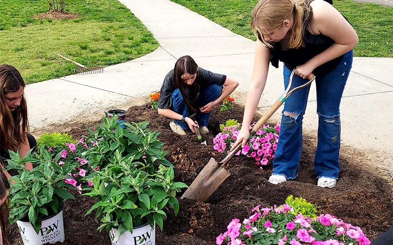 Brianna Adcock, Sarah Brawley and Adi Waters of Fannin’s FFA had no problem getting dirty to beautify the Toccoa River Park in McCaysville.
