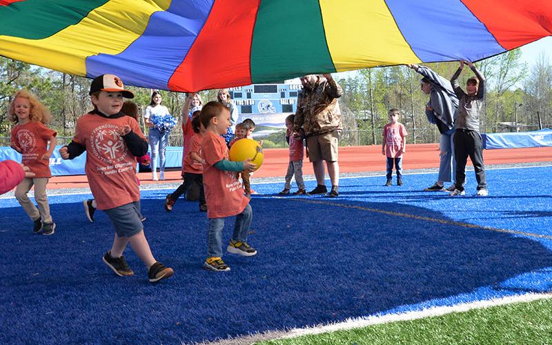 Fannin County Special Olympics Track and Field events returned to the Fannin County High School football field for the first time in seven years Friday morning, April 12, thanks to a day filled with sunshine. Pre-k and Kindergarten athletes from East Fannin Elementary School rush to get through the parachute roof before it comes down.