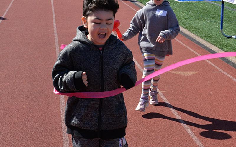 Nathaniel from Blue Ridge Elementary breaks the tape in the 50 yard dash.