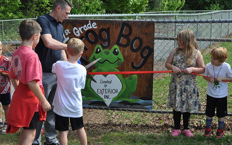Jeremy Collis, Brayden Collis, and Joel Curtis cut the ribbon to officially open up the Frog Bog at West Fannin Elementary School. The ceremony last week marked the celebration of an ongoing project at the school.