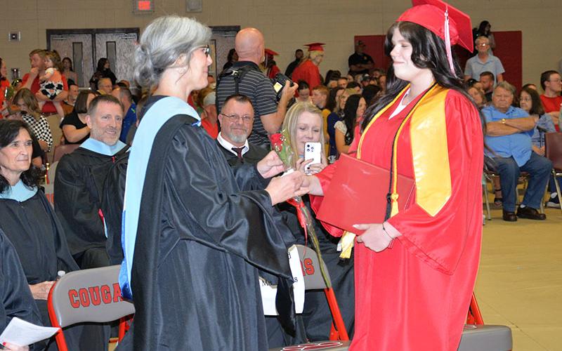 Nicole Marrie presents her mother, Shannon Marie, a rose, signifying Nicole is the last child in the family to graduate high school.