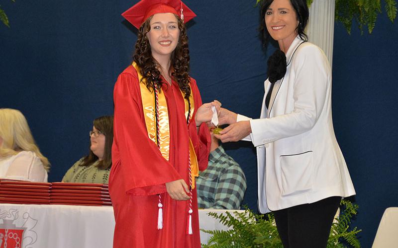 Class of 2024 Valedictorian Maddie Cribbs was honored for her achievement by Principal Holly Smith after Cribbs delivered her valedictory address to a gym filled with family, friends and school officials.