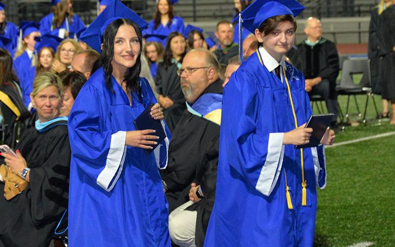 All smiles as these graduates collect their diplomas in front of fellow students, family and friends.