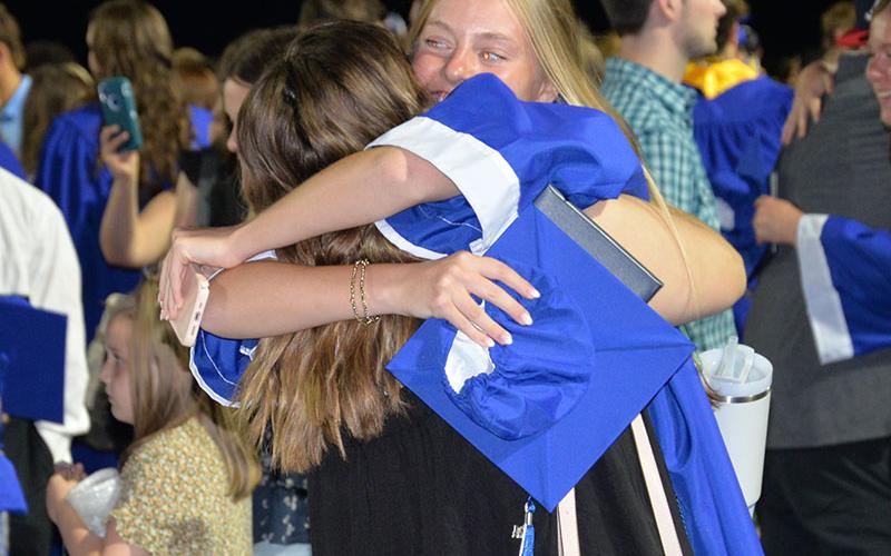 Graduate embraced after graduation ceremony and FCHS.