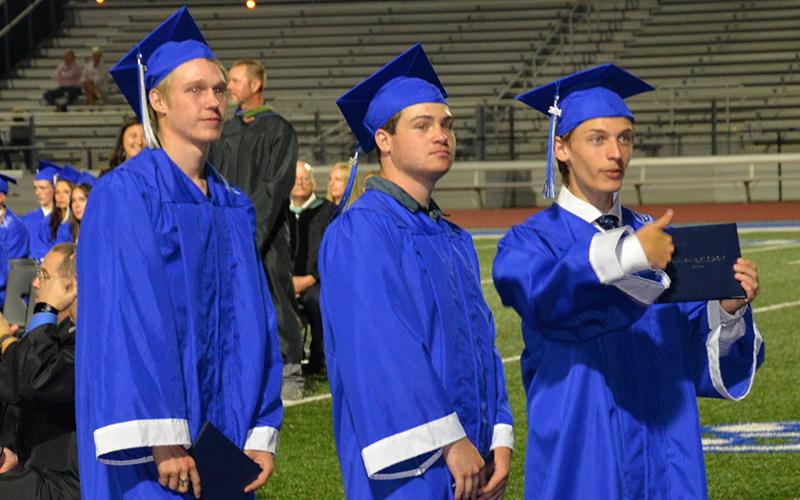 Graduate gives family and friends a thumbs up.